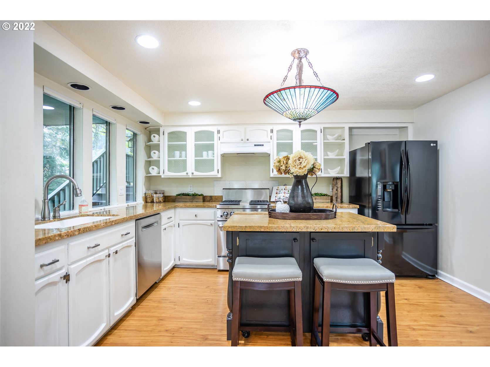 2017 Kimberly Drive Eugene, OR 97405 - Photo 5 of 32 a kitchen with stainless steel appliances a dining table chairs and wooden floor
