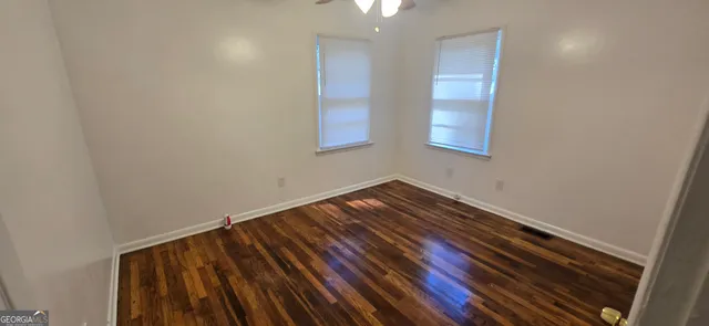 a view of room with wooden floor