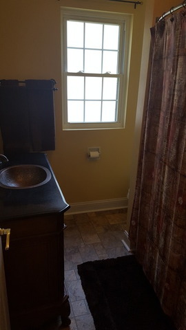 459 Herman Street Crete, IL 60417 - Photo 12 of 20 a bathroom with a sink a toilet and a window
