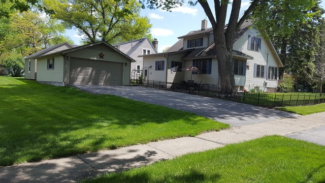 459 Herman Street Crete, IL 60417 - Photo 3 of 20 a front view of a house with a garden and yard