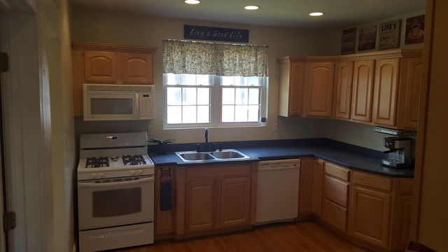 459 Herman Street Crete, IL 60417 - Photo 6 of 20 a kitchen with stainless steel appliances granite countertop a stove a sink and a microwave