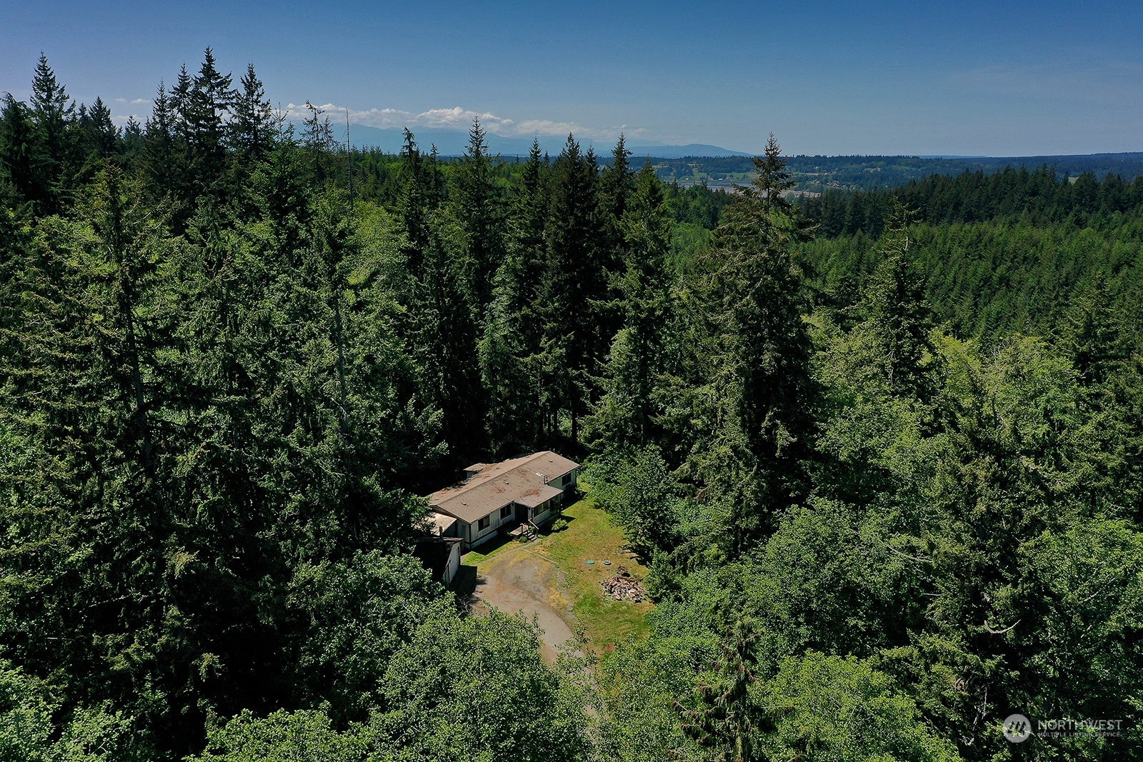 an aerial view of a house with lots of trees
