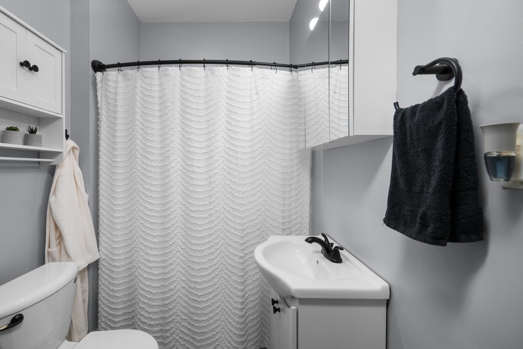 716 Morton Avenue Kewanee, IL 61443 - Photo 14 of 26 a bathroom with a sink a toilet and a mirror