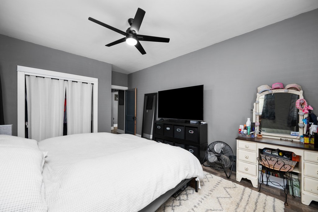 716 Morton Avenue Kewanee, IL 61443 - Photo 16 of 26 a bedroom with a bed and a flat screen tv