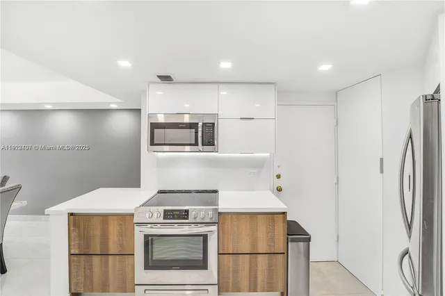 a kitchen with a stove and a refrigerator