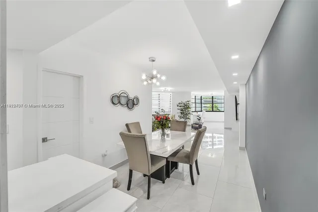 a view of a dining room with furniture and a chandelier