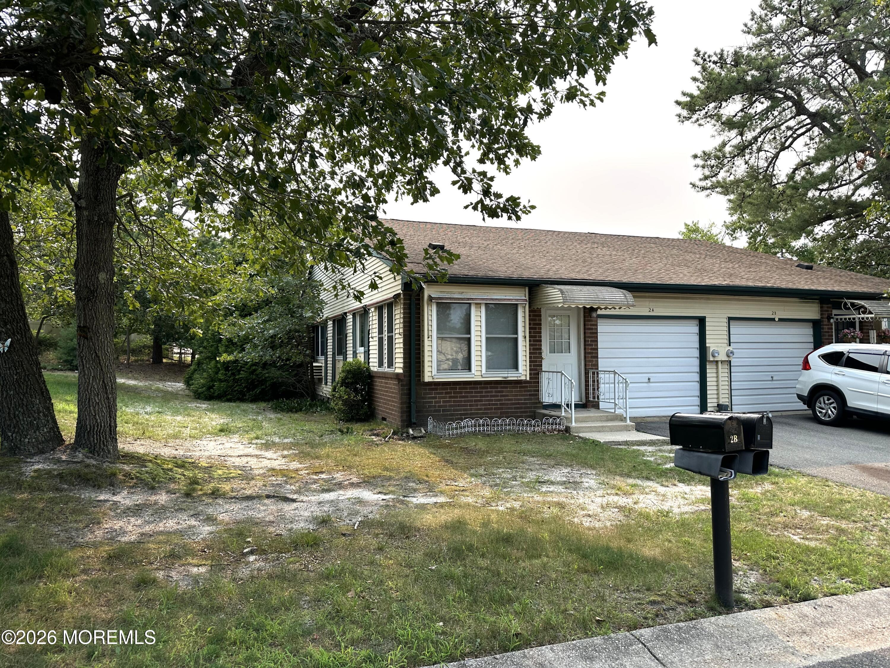 2B Fallbrook Street, Unit 52 Whiting, NJ 08759 - Photo 2 of 14 a front view of a house with garden