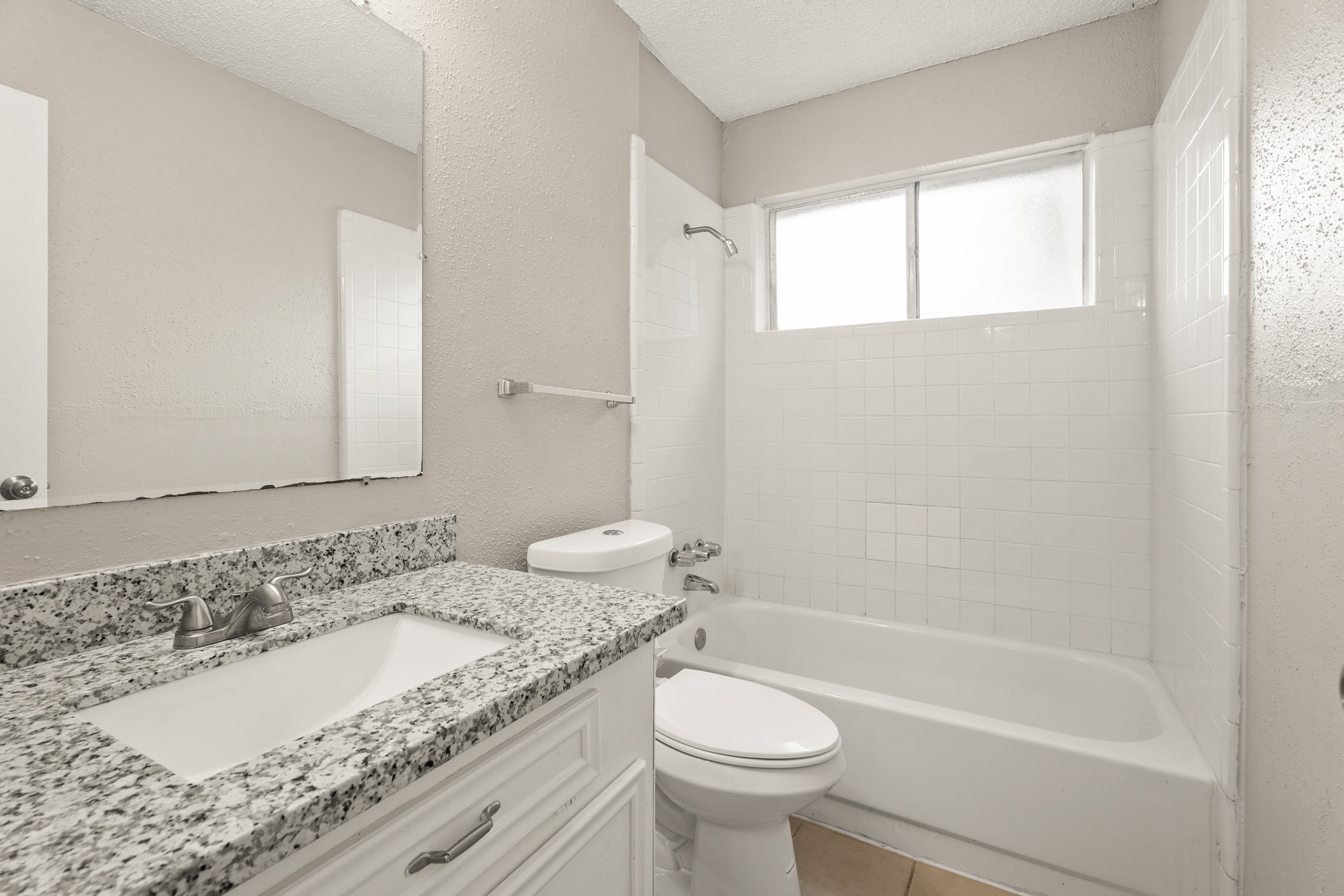 15911 Mill Point Drive Houston, TX 77059 - Photo 11 of 16 a bathroom with a granite countertop sink a toilet and bathtub