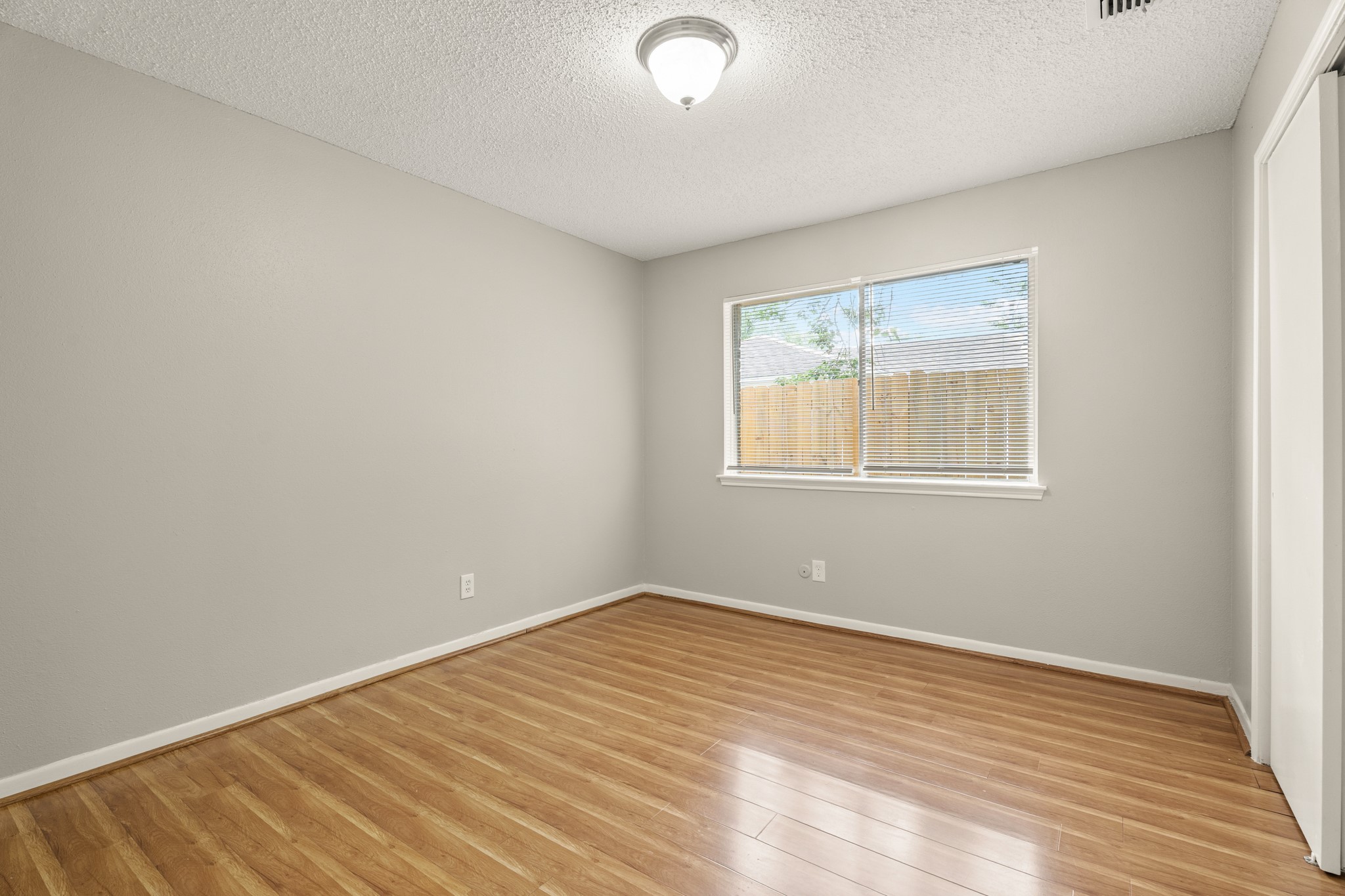 15911 Mill Point Drive Houston, TX 77059 - Photo 12 of 16 a view of empty room with wooden floor and fan