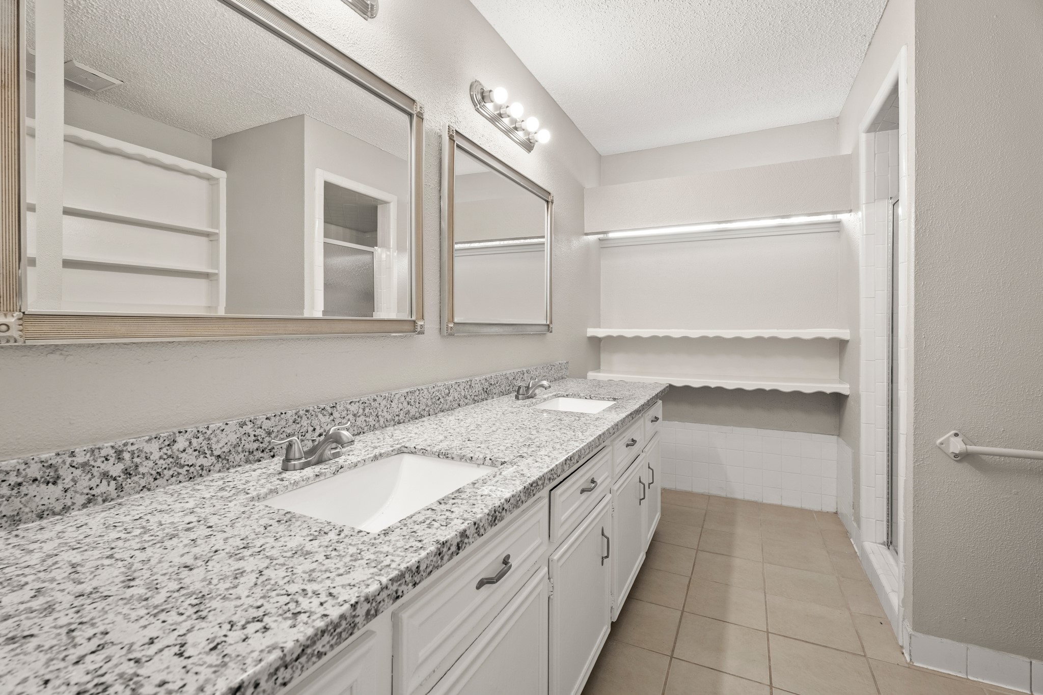 15911 Mill Point Drive Houston, TX 77059 - Photo 13 of 16 a bathroom with a granite countertop sink and a bathtub