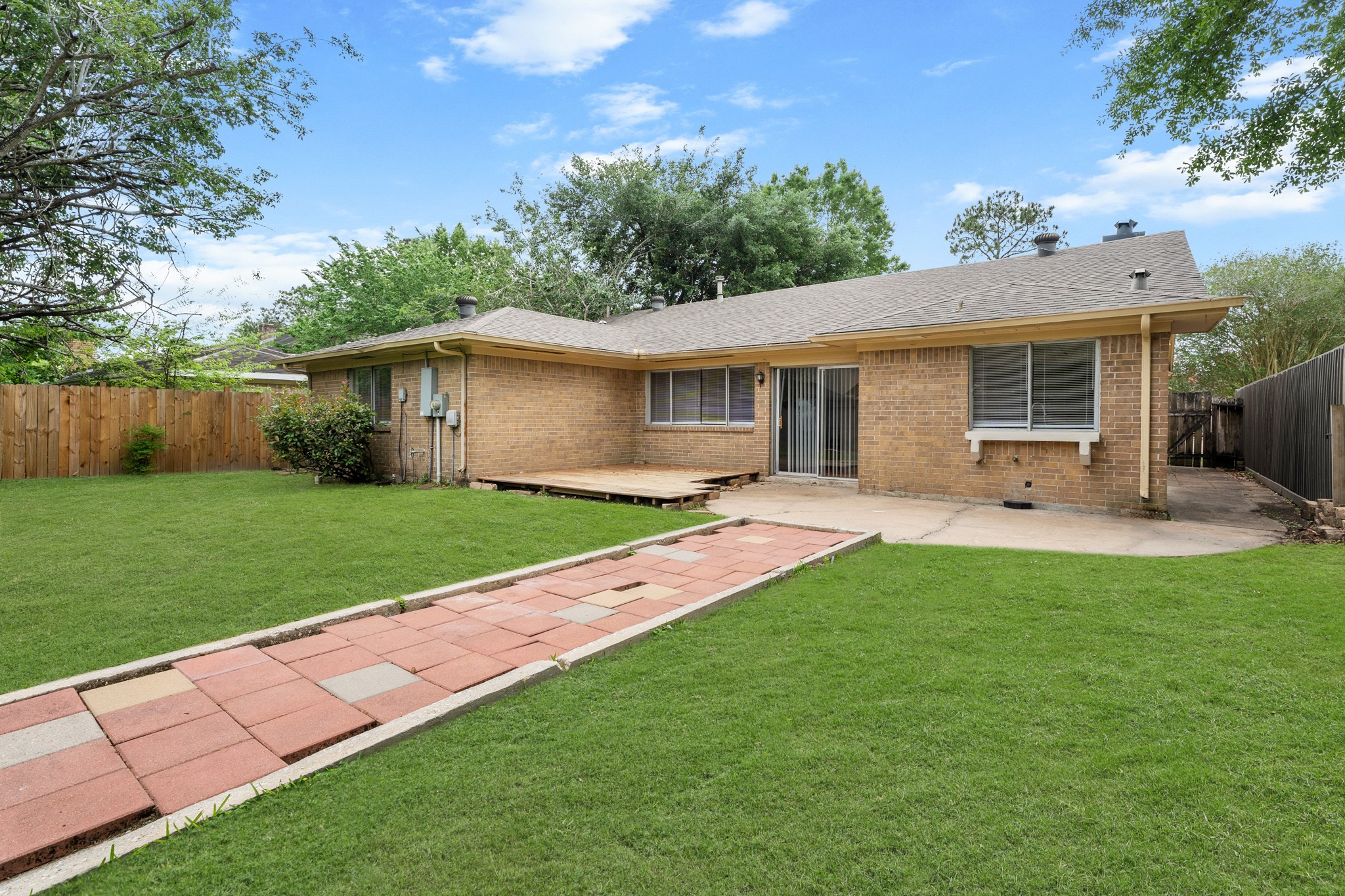 15911 Mill Point Drive Houston, TX 77059 - Photo 15 of 16 a view of a house with a backyard