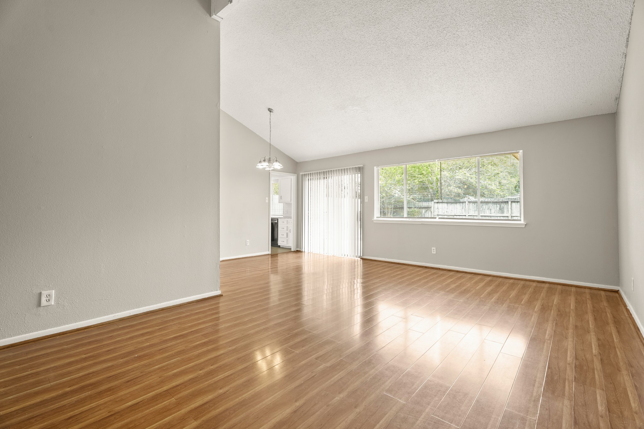 15911 Mill Point Drive Houston, TX 77059 - Photo 4 of 16 an empty room with wooden floor and windows
