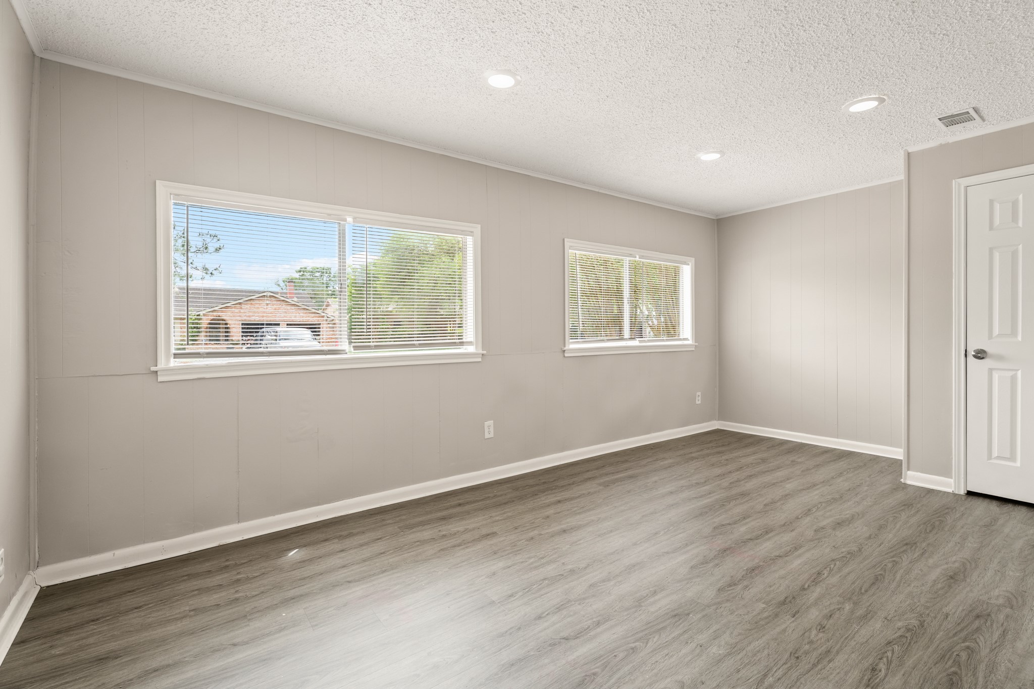 15911 Mill Point Drive Houston, TX 77059 - Photo 8 of 16 a view of an empty room with wooden floor and a window