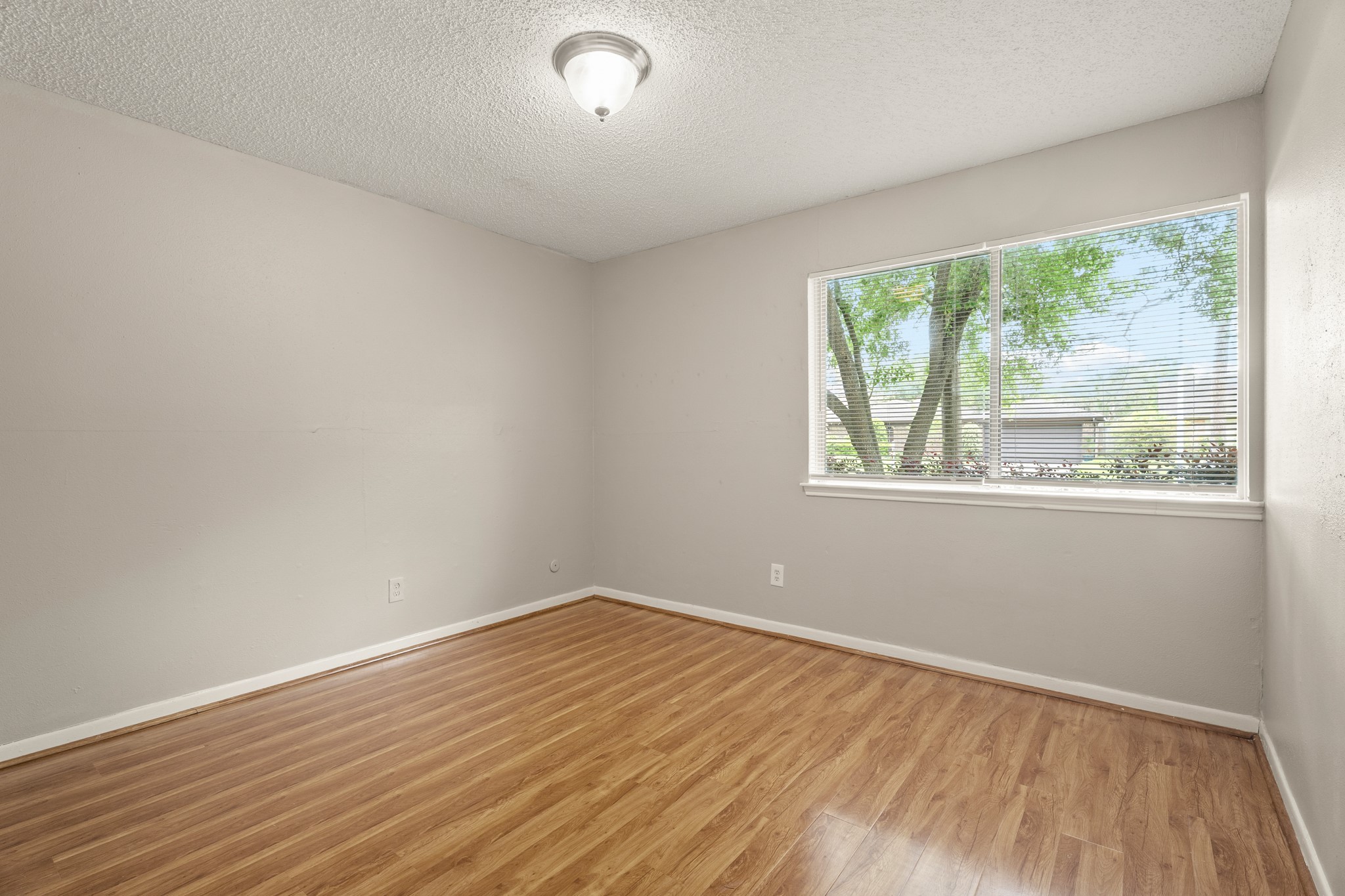 15911 Mill Point Drive Houston, TX 77059 - Photo 10 of 16 wooden floor in an empty room with a window