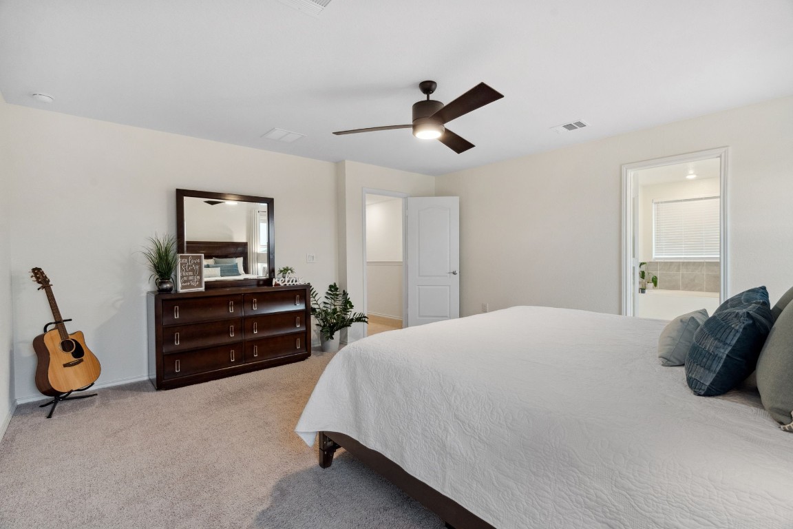 6509 Wagon Spring Street Del Valle, TX 78617 - Photo 19 of 35 The primary bedroom easily accommodates a king-sized bed, with plenty of room to spare