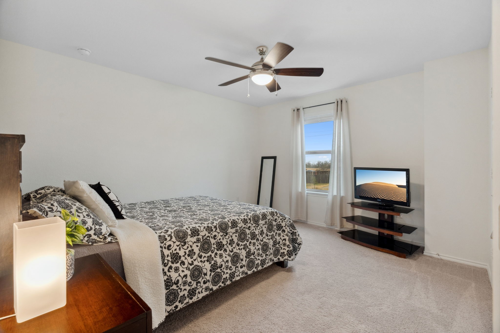 6509 Wagon Spring Street Del Valle, TX 78617 - Photo 22 of 35 The secondary bedrooms are generously sized and come with modern ceiling fan and spacious two-door closets