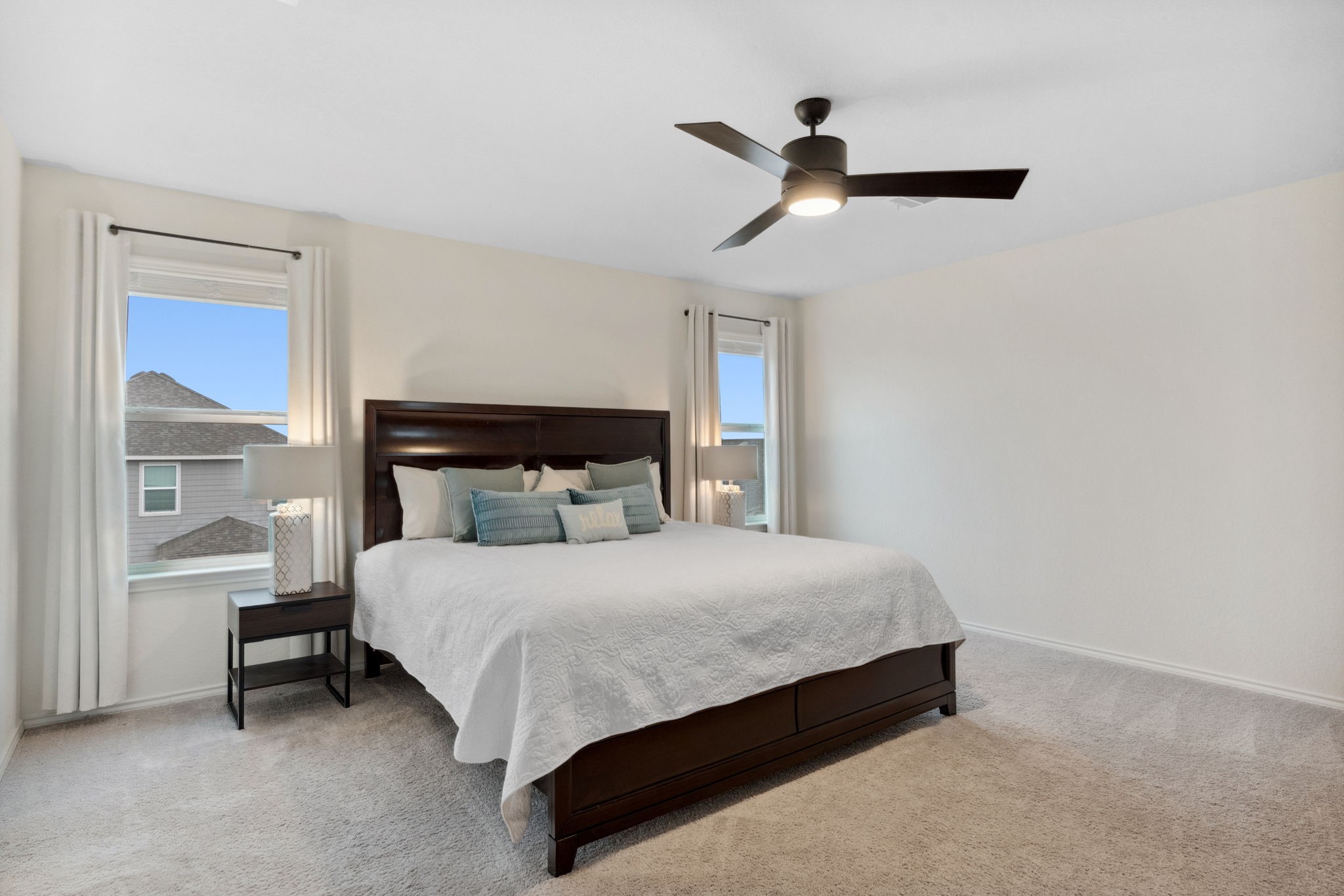 6509 Wagon Spring Street Del Valle, TX 78617 - Photo 4 of 35 The luxurious primary bedroom is generously sized and includes a sleek ceiling fan and a huge walk-in closet