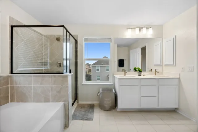 a bathroom with a bathtub sink and mirror