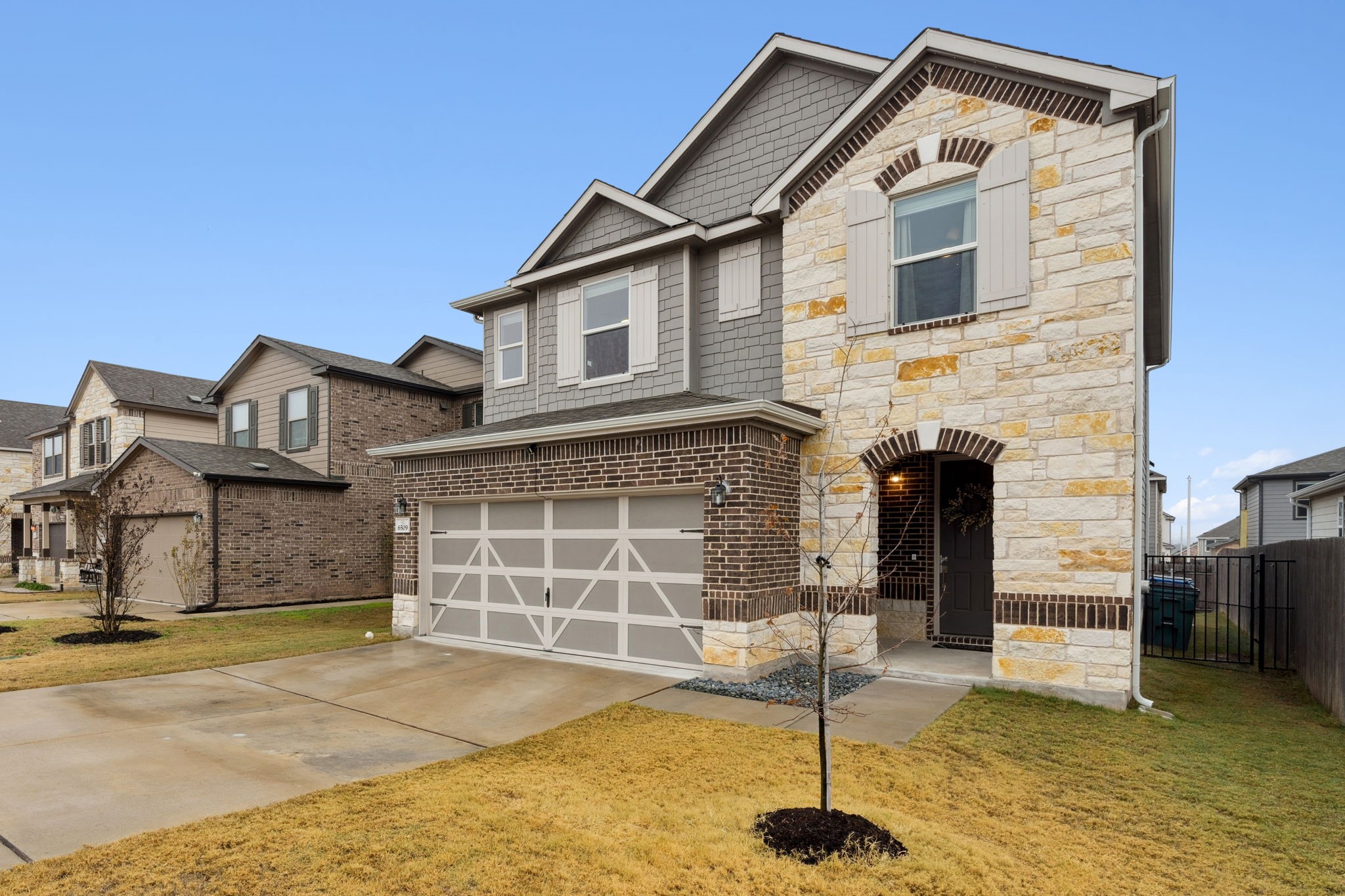 6509 Wagon Spring Street Del Valle, TX 78617 - Photo 7 of 35 Beautiful brick and stone façade along with a well kept yard greets you at the front yard