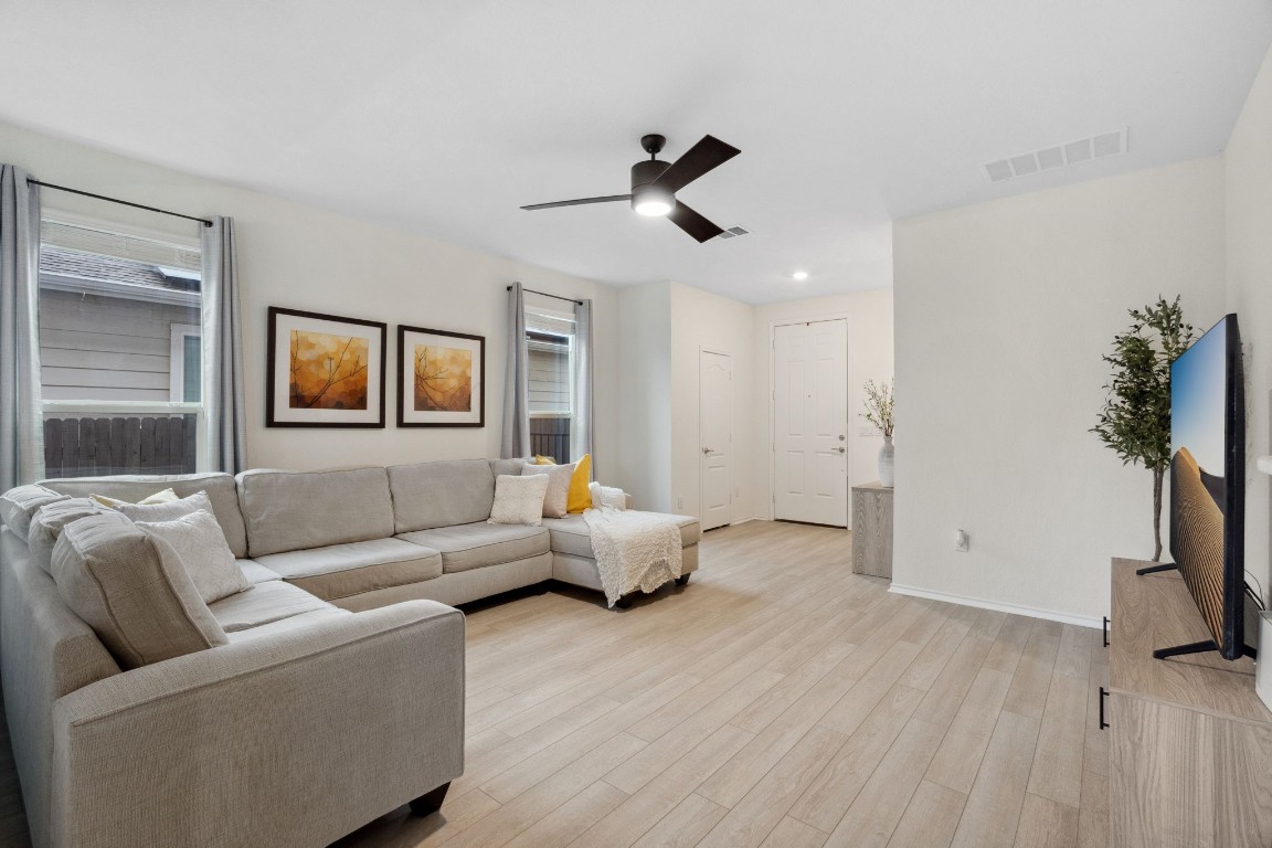 6509 Wagon Spring Street Del Valle, TX 78617 - Photo 10 of 35 The gorgeous vinyl flooring offers a cozy, low-maintenance look while the sleek ceiling fan adds a contemporary touch.