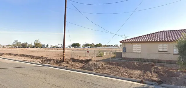 a view of a house next to a yard and ocean view