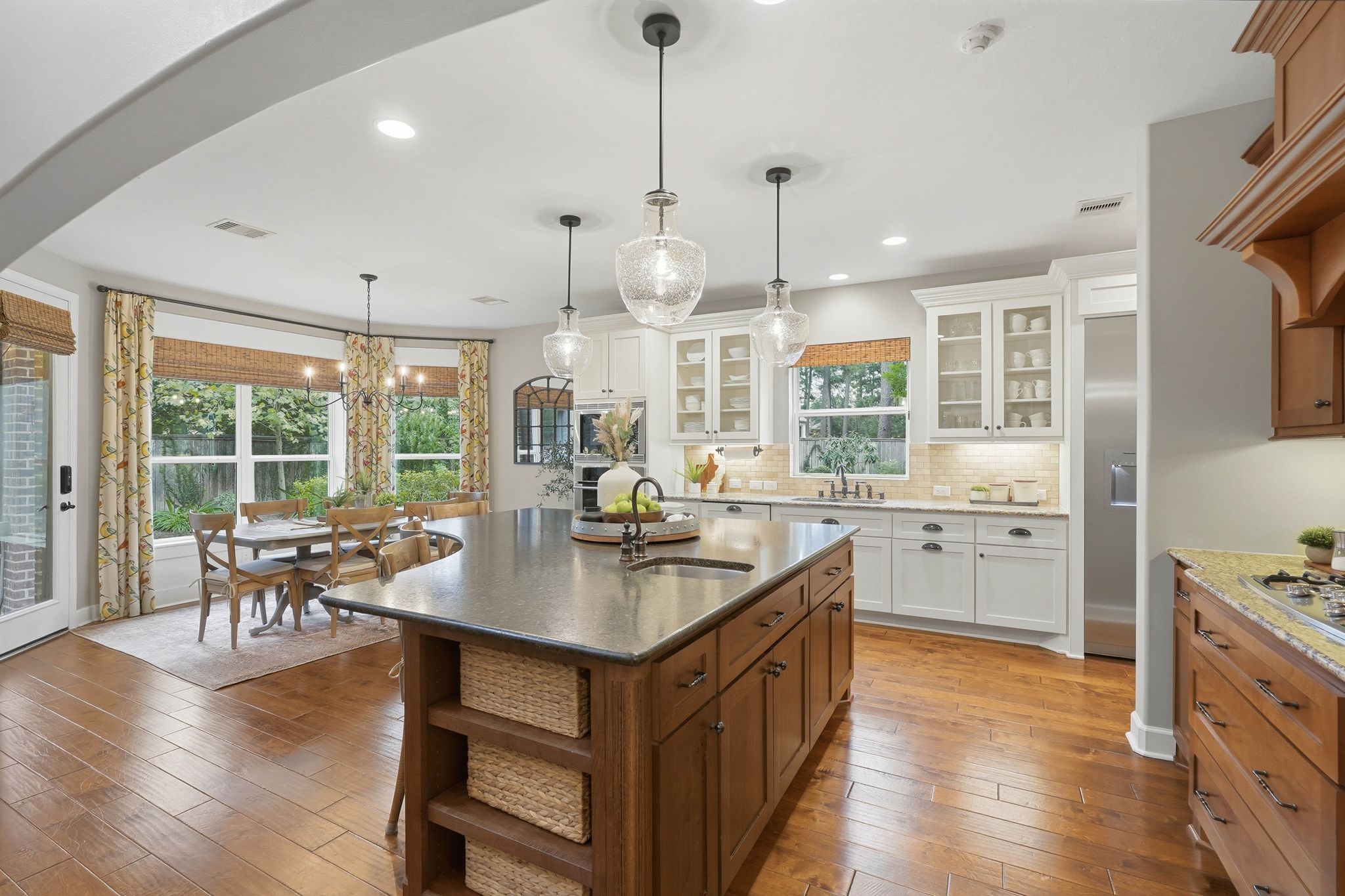 147 West Valera Ridge Place The Woodlands, TX 77389 - Photo 14 of 50 Well-appointed kitchen with oversized island w/second sink, granite countertops, custom cabinetry, and a bright breakfast area.