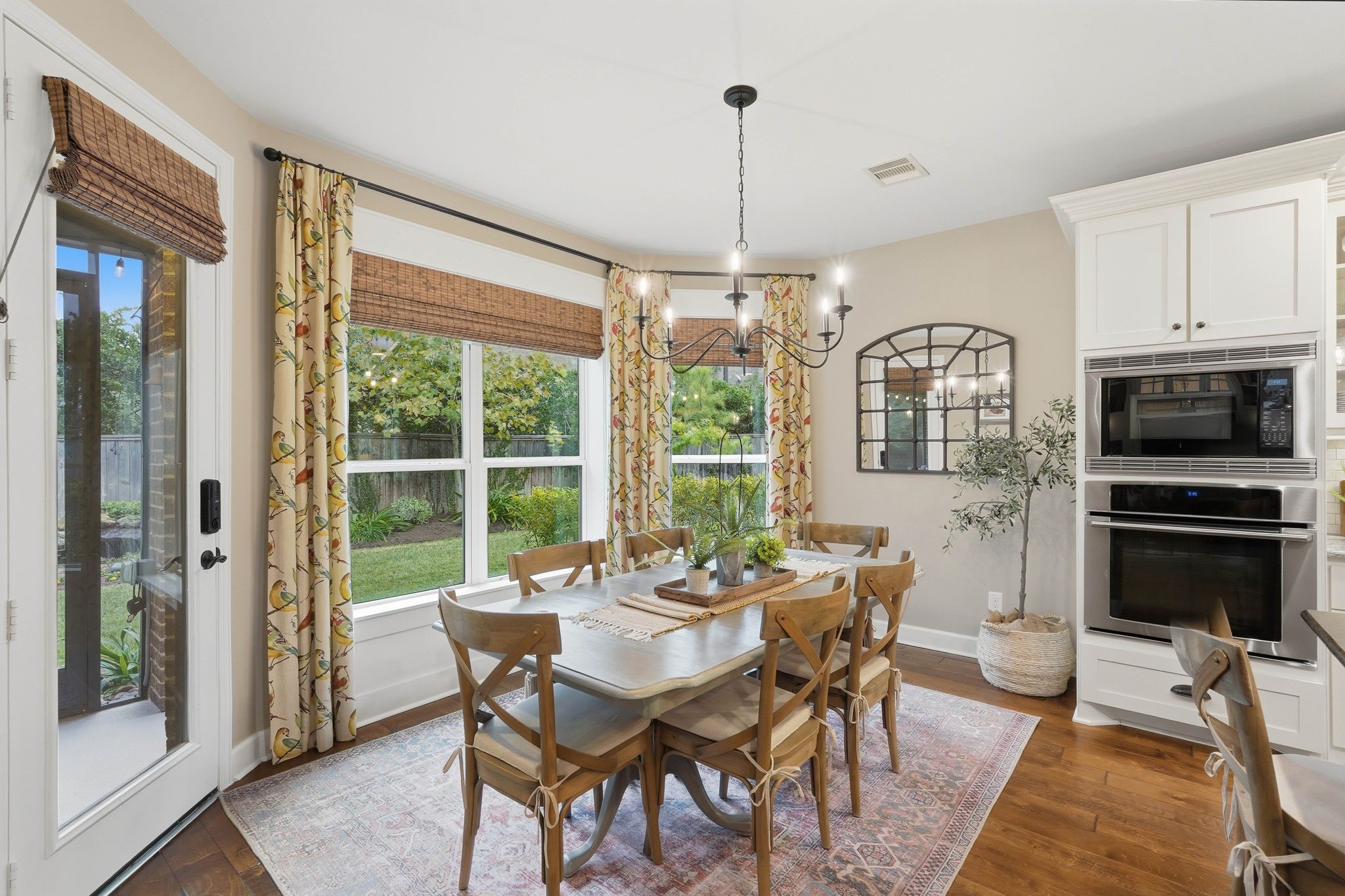 147 West Valera Ridge Place The Woodlands, TX 77389 - Photo 17 of 50 Bright breakfast nook featuring oversized windows, backyard views, and seamless indoor-outdoor flow.