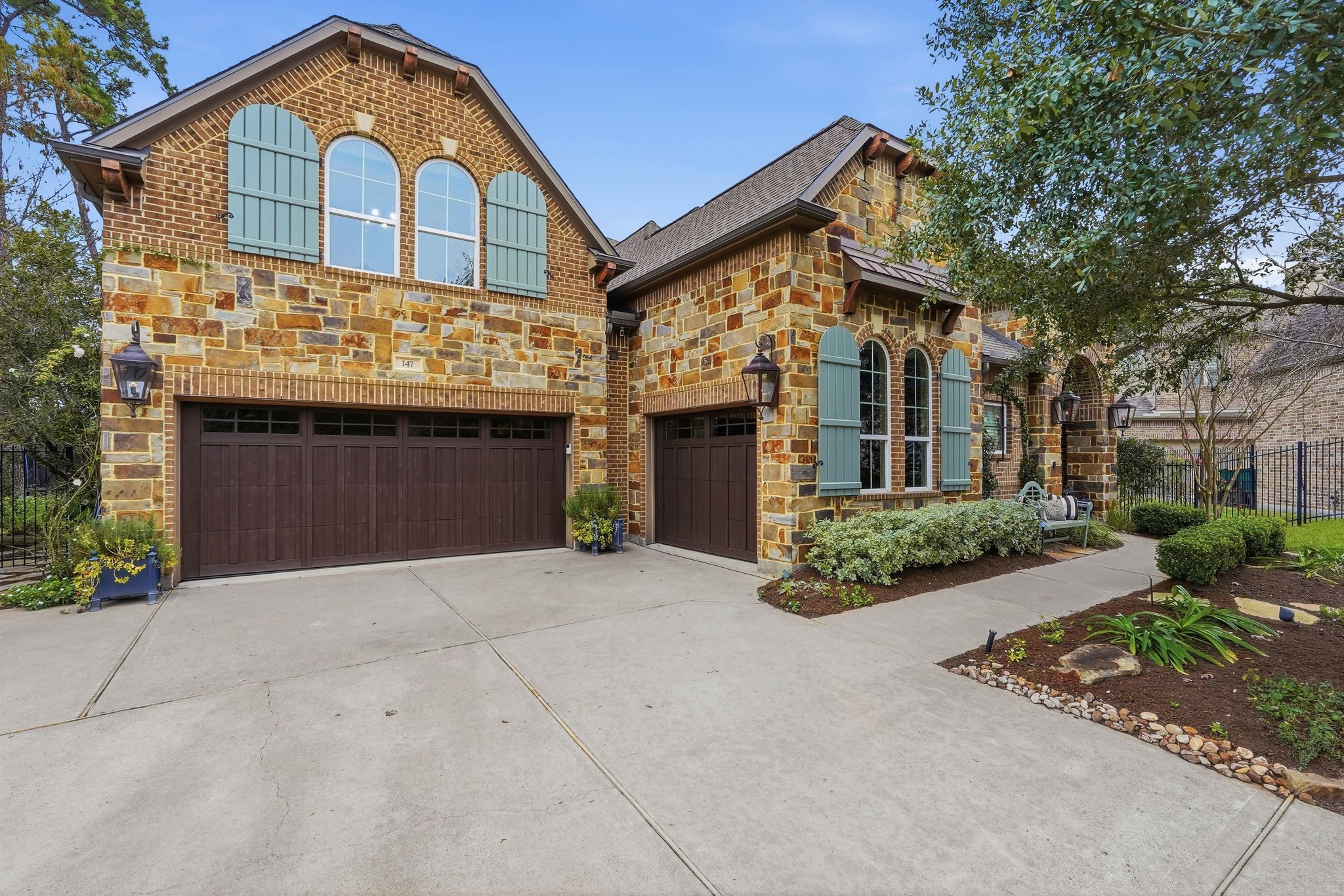 147 West Valera Ridge Place The Woodlands, TX 77389 - Photo 2 of 50 This home features a three car garage and large driveway for multiple vehicles. The third garage to the right is currently being used as a home gym. It can fit a car or you can use this space for extra storage.