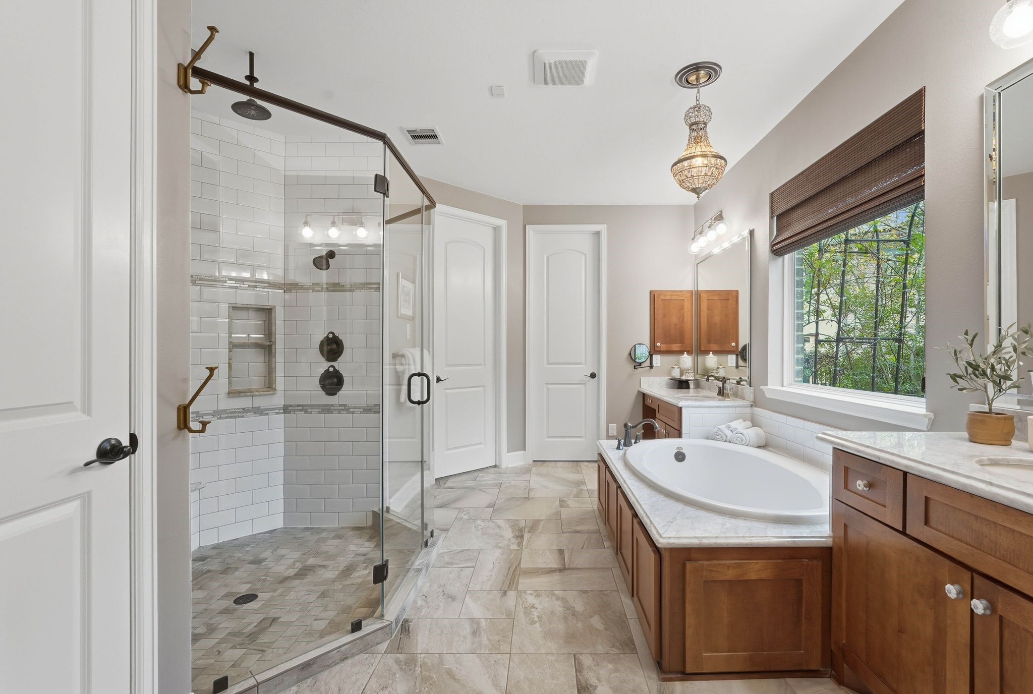147 West Valera Ridge Place The Woodlands, TX 77389 - Photo 23 of 50 Luxurious primary bath offering a frameless walk-in shower, soaking tub, dual vanities, designer lighting, and timeless finishes.