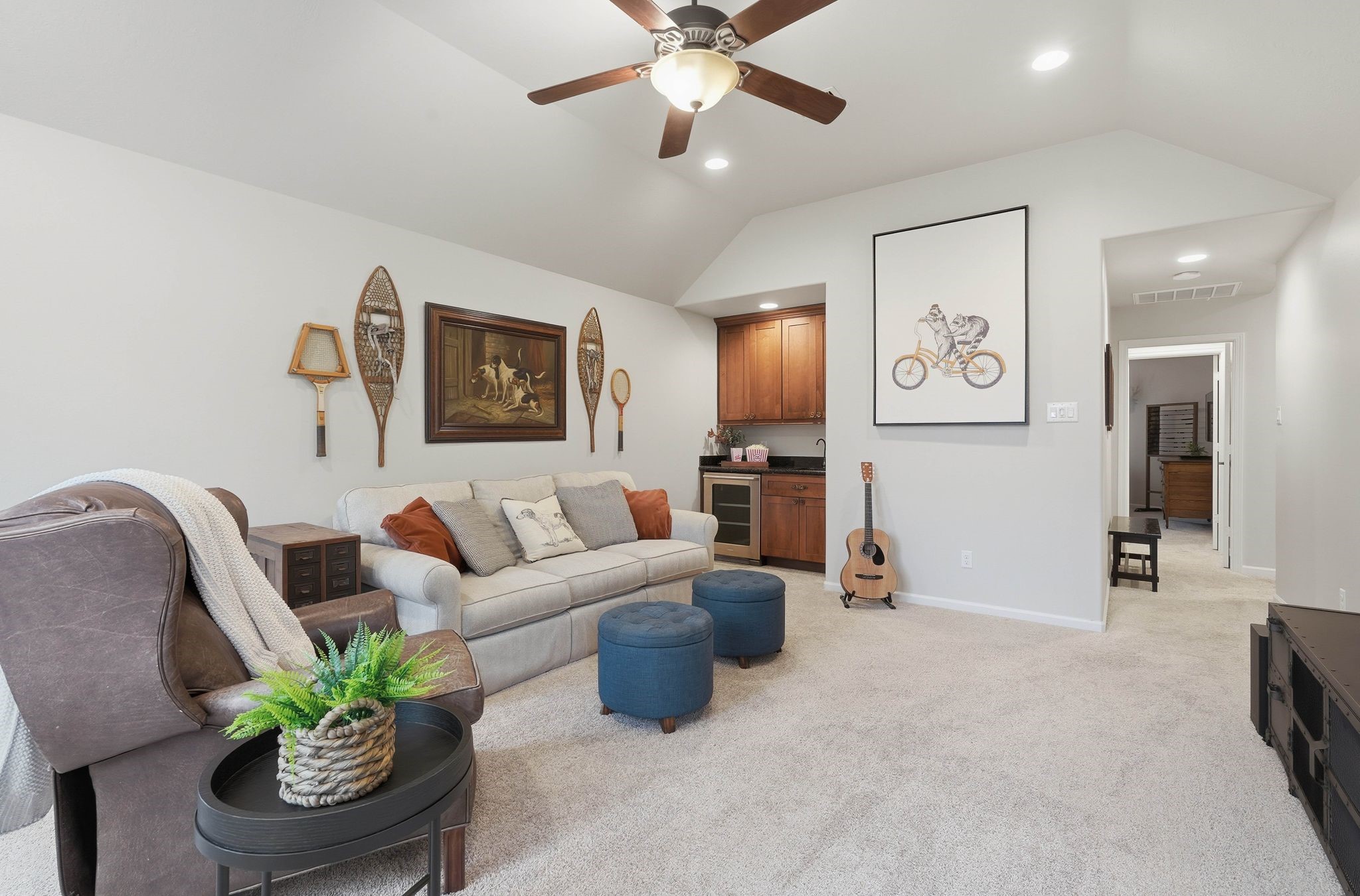 147 West Valera Ridge Place The Woodlands, TX 77389 - Photo 26 of 50 Spacious upstairs game room with vaulted ceiling, ceiling fan, and a convenient wet bar—ideal for entertaining, movie nights, or relaxing.