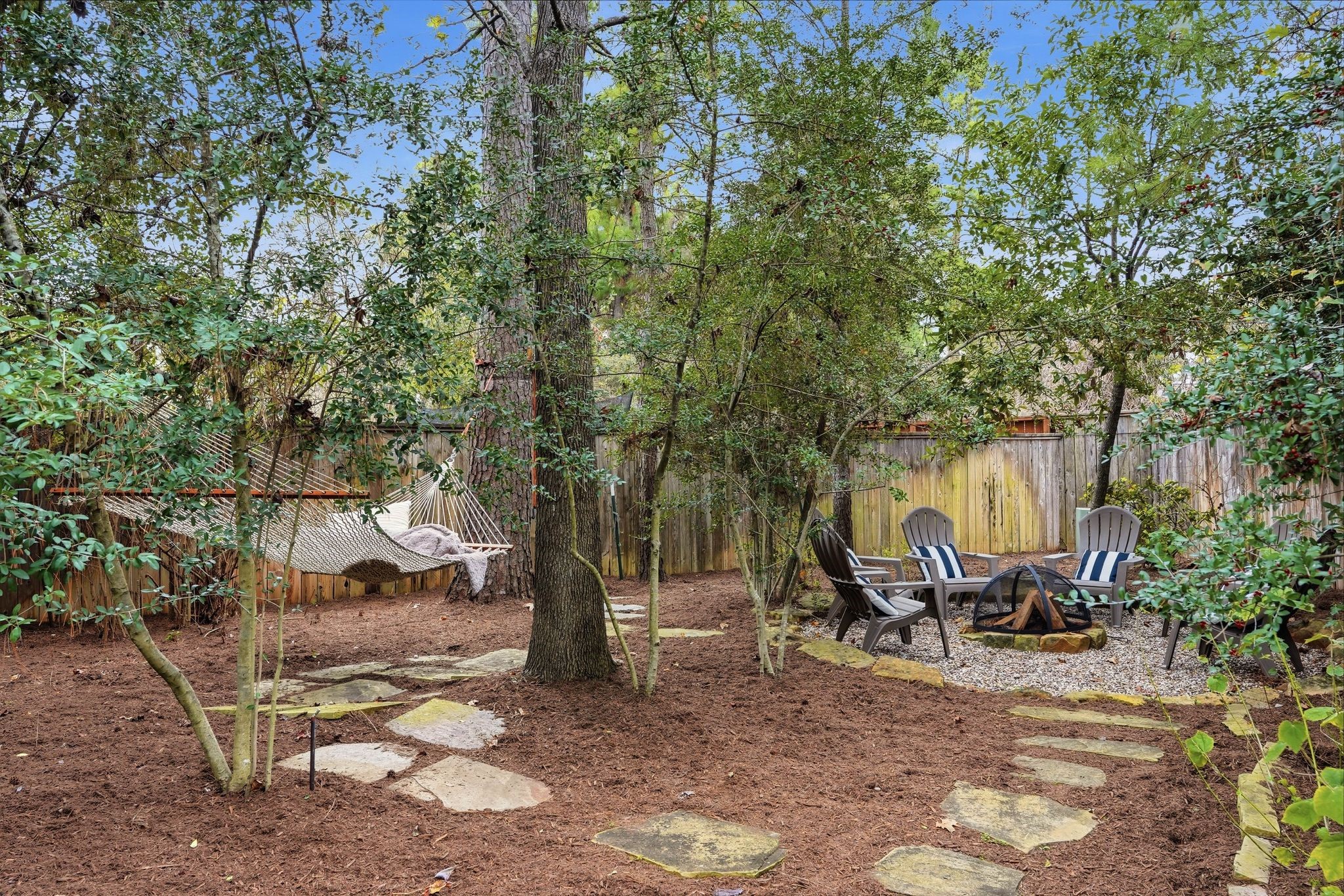 147 West Valera Ridge Place The Woodlands, TX 77389 - Photo 39 of 50 Hang out in the northwest corner of the yard and enjoy the hammock and enjoy roasting marshmallows around the fire.