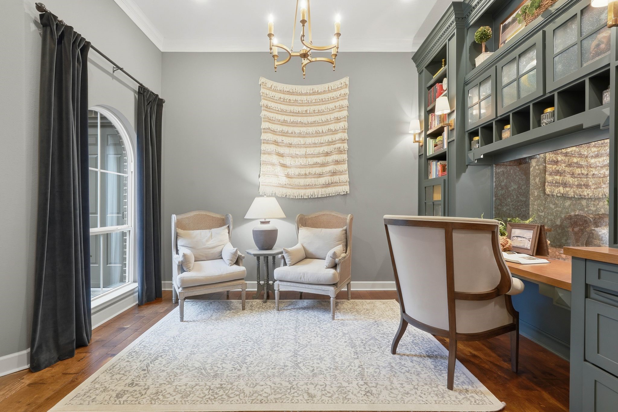 147 West Valera Ridge Place The Woodlands, TX 77389 - Photo 7 of 50 Designer home office offering custom built-ins, hardwood floors, a relaxing sitting area, and discreet printer and device drawers for an organized, cord-free environment.