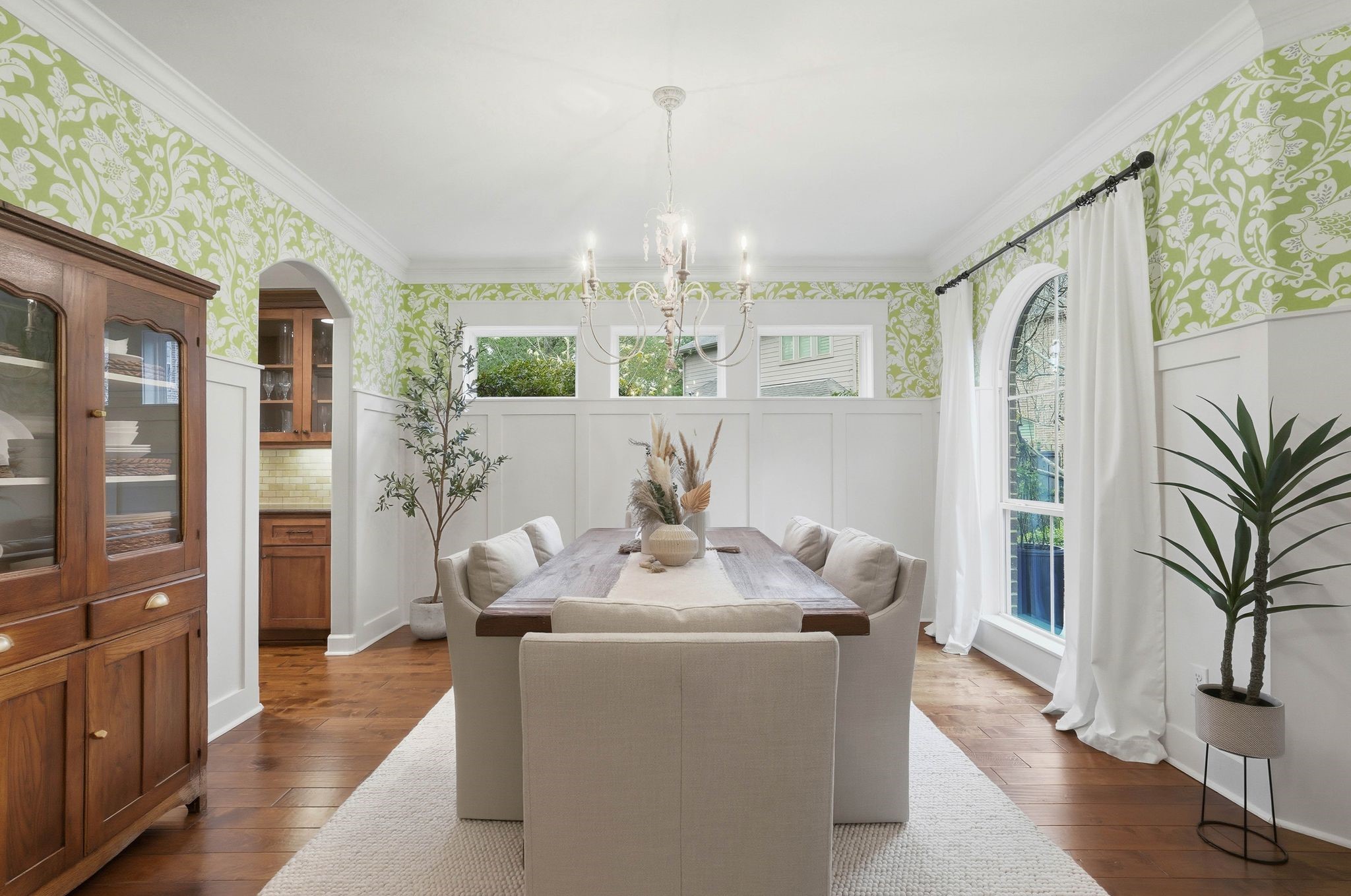 147 West Valera Ridge Place The Woodlands, TX 77389 - Photo 8 of 50 Stylish dining room with charming wallpaper, custom wainscoting, beautiful chandelier and abundant natural light.
