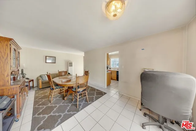 a dining room with furniture and a chandelier