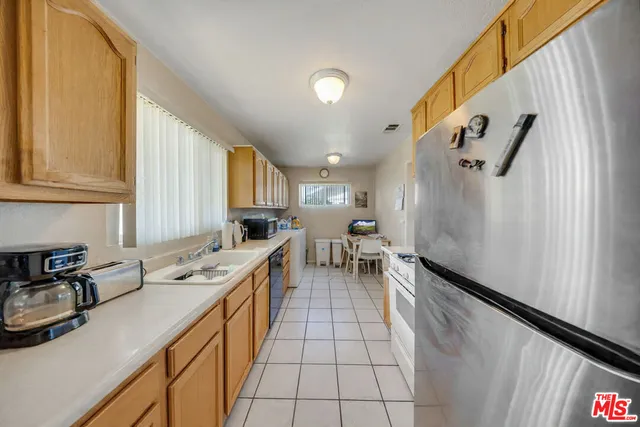 a kitchen with a sink appliances and cabinets
