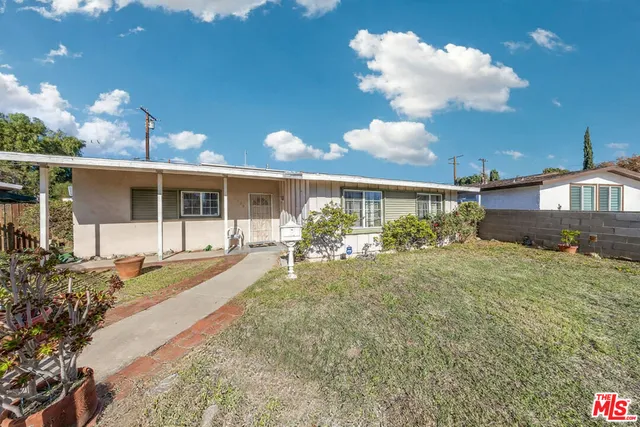 a view of a house with backyard porch and sitting area
