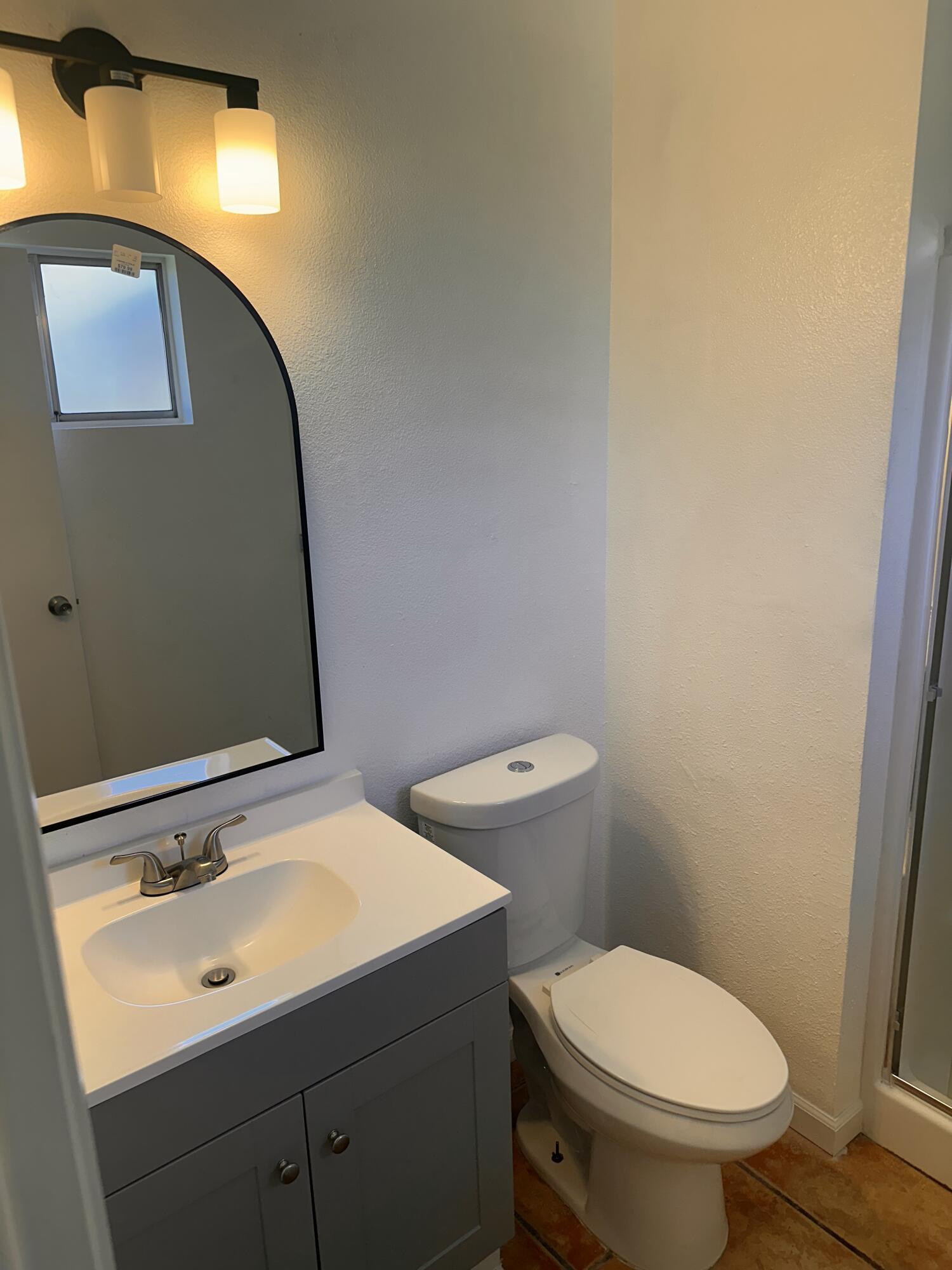 30880 Farr Road Visalia, CA 93291 - Photo 18 of 27 a bathroom with a toilet sink and mirror