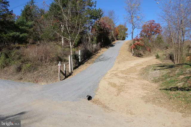 a view of a yard with wooden fence