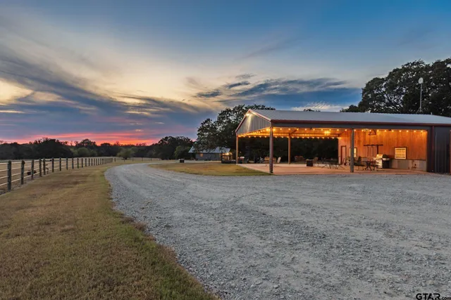 a view of a house with a yard and sitting area