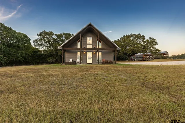 a kitchen with stainless steel appliances granite countertop a refrigerator a stove a sink and a microwave