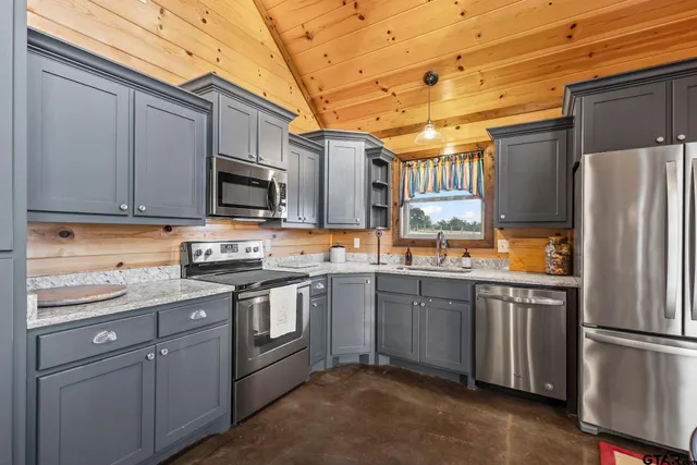 a living room with furniture wooden floor and a large window