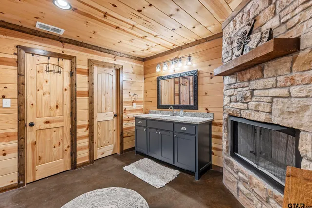 a spacious bedroom with a bed and a dresser