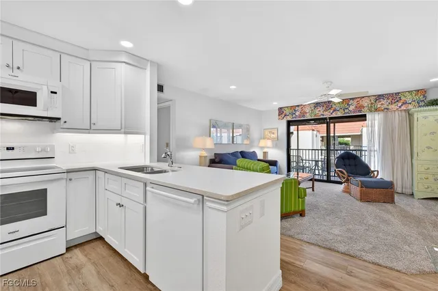 a view of a dining room with furniture a rug and wooden floor