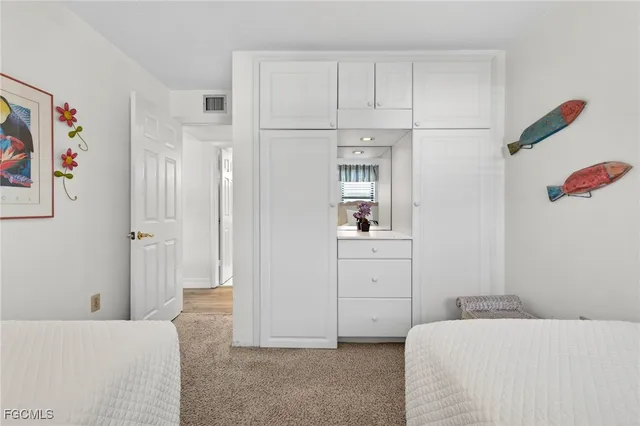 a view of a house with a yard and potted plants