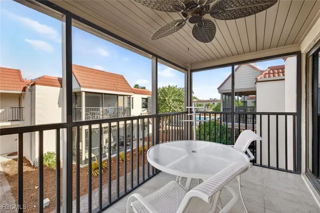 a kitchen filled with white cabinets and appliances