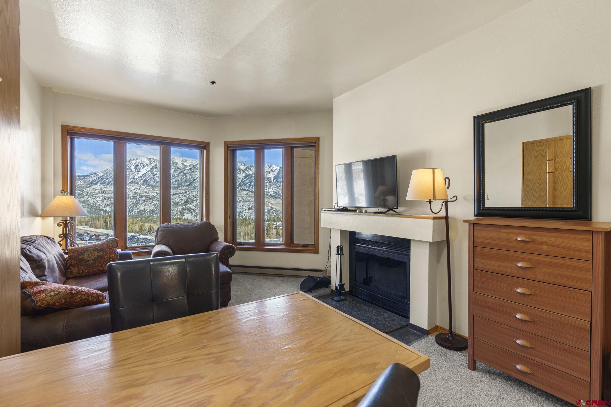 71 Needles Way, Unit 440 Durango, CO 81301 - Photo 1 of 31 a living room with furniture a fireplace and a flat screen tv