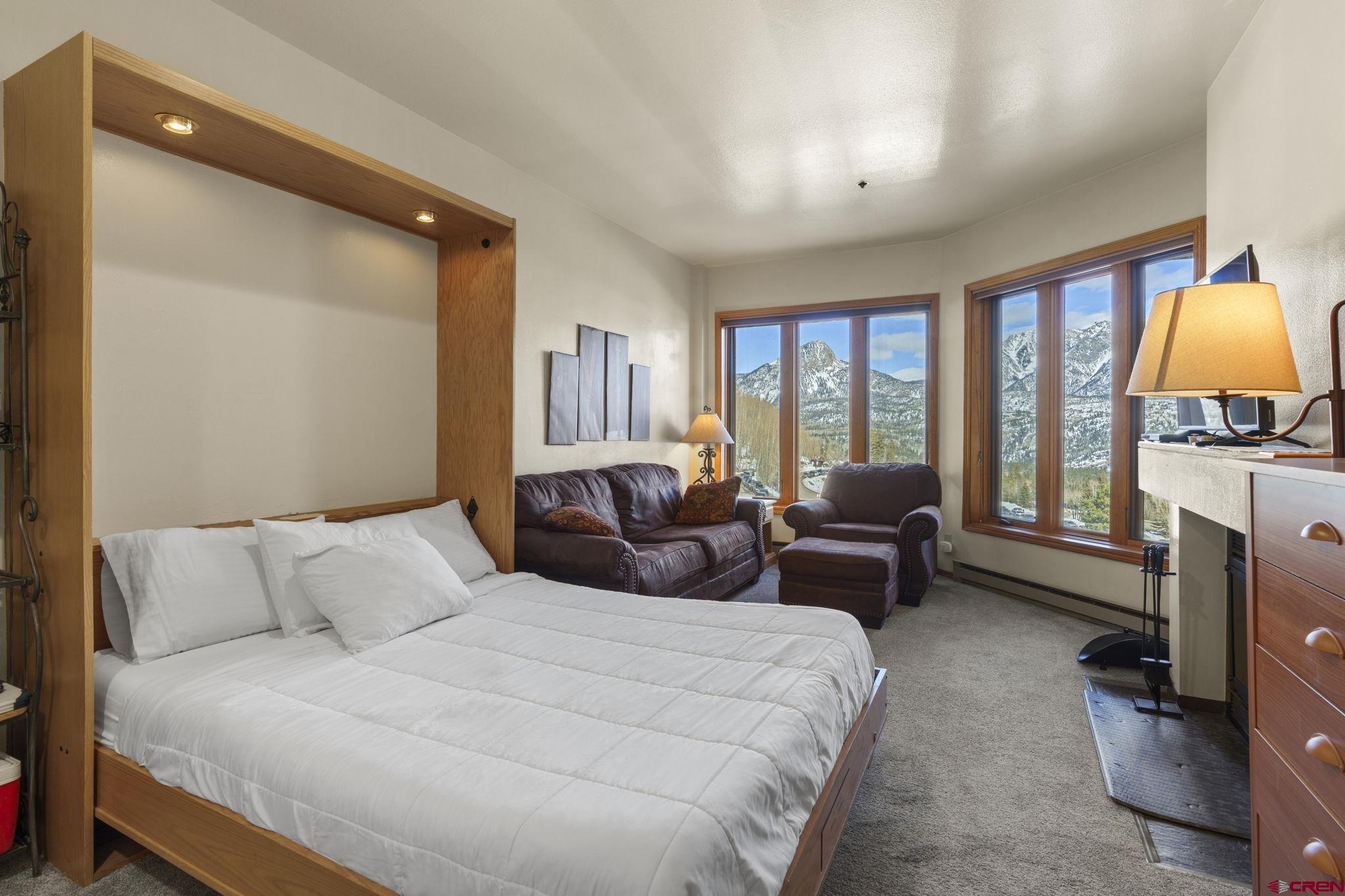 71 Needles Way, Unit 440 Durango, CO 81301 - Photo 2 of 31 a bedroom with a bed couch and a flat tv screen next to a window