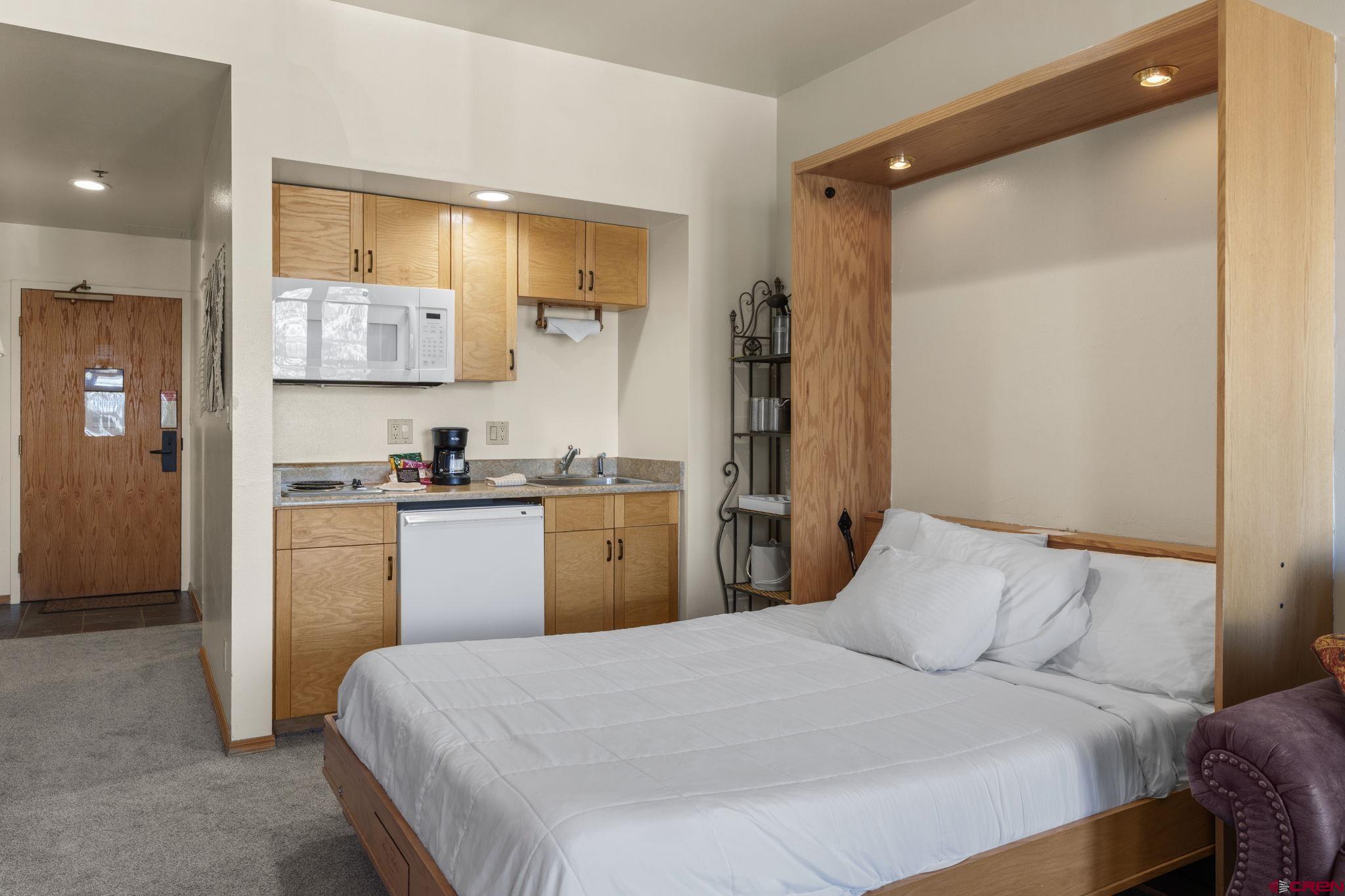 71 Needles Way, Unit 440 Durango, CO 81301 - Photo 5 of 31 a bedroom with a bed and a view of kitchen