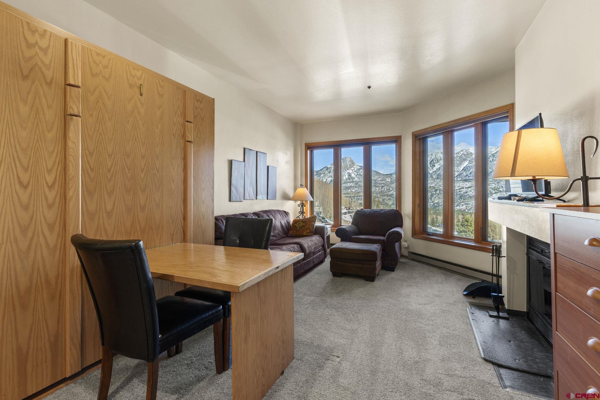 71 Needles Way, Unit 440 Durango, CO 81301 - Photo 7 of 31 a living room with furniture a fireplace and a large window
