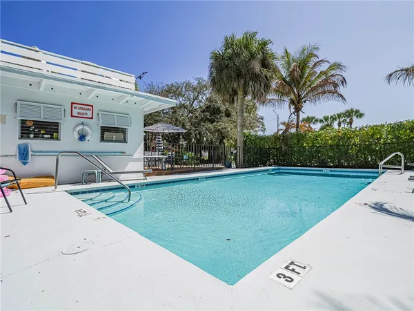 a view of a swimming pool with a garden and trees
